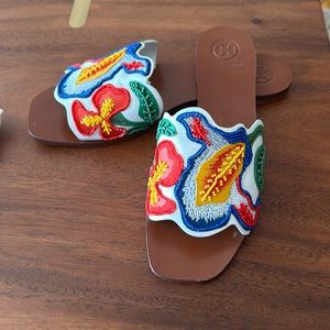 Tory Burch embroidered slip on sandals.